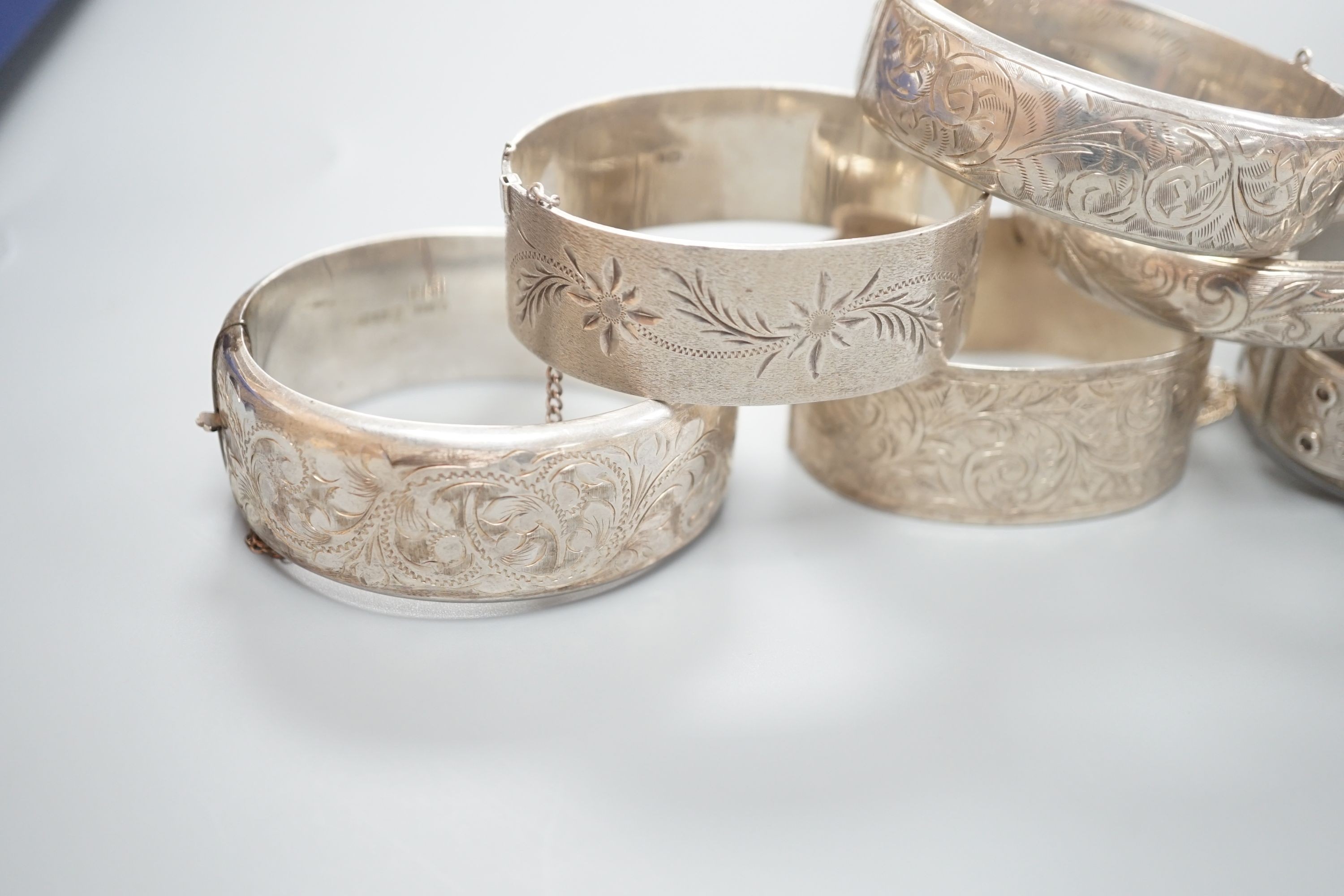 A Victorian silver bangle, Birmingham, 1885 and five later silver bangles.